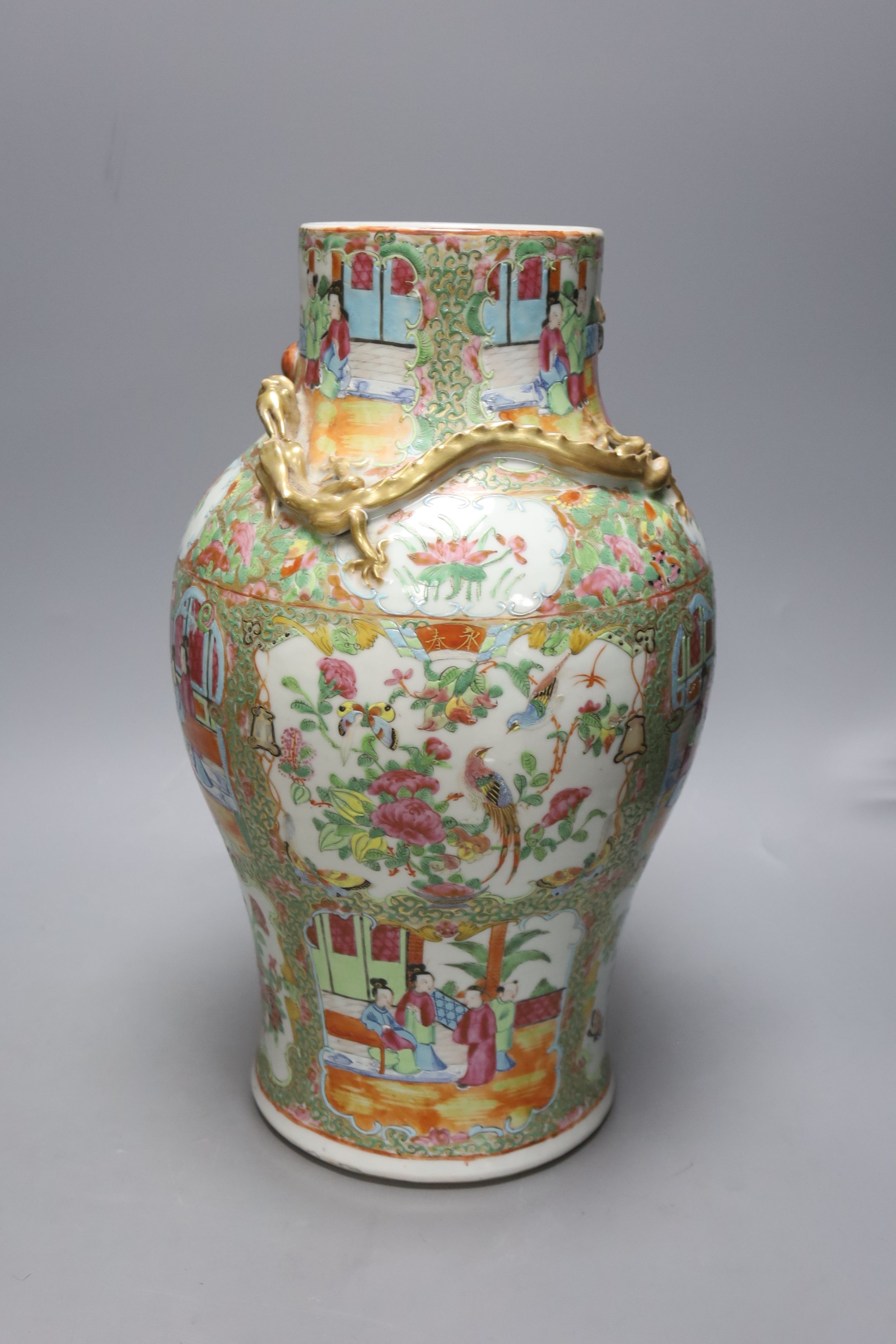 A pair of 19th century Chinese famille rose vases, height 30.5cm and a similar larger vase, 37.5cm (3)